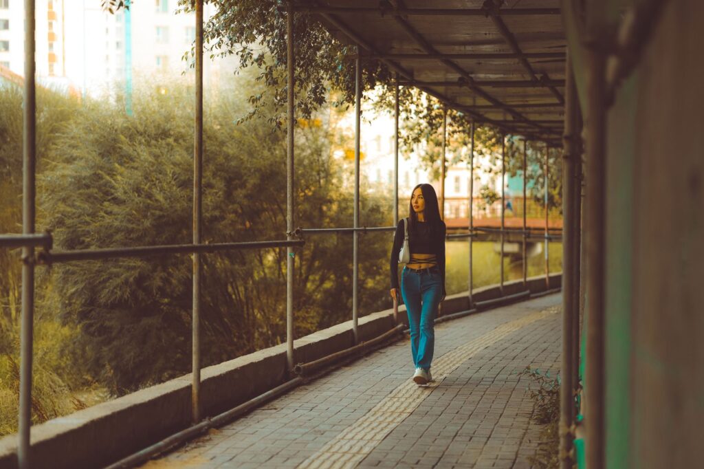 A young woman walking outdoors to support weight management with PCOS