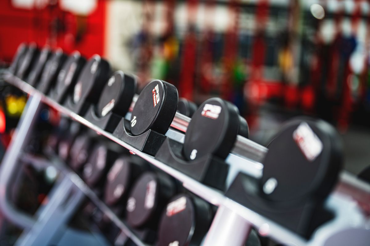 Dumbbells in a gym, resistance training to protect muscle while on weight loss medication